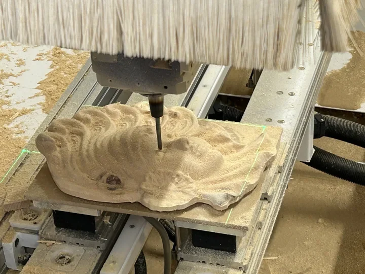Venetian mask in Swiss stone pine during three-axis CNC machining with closely spaced milling passes