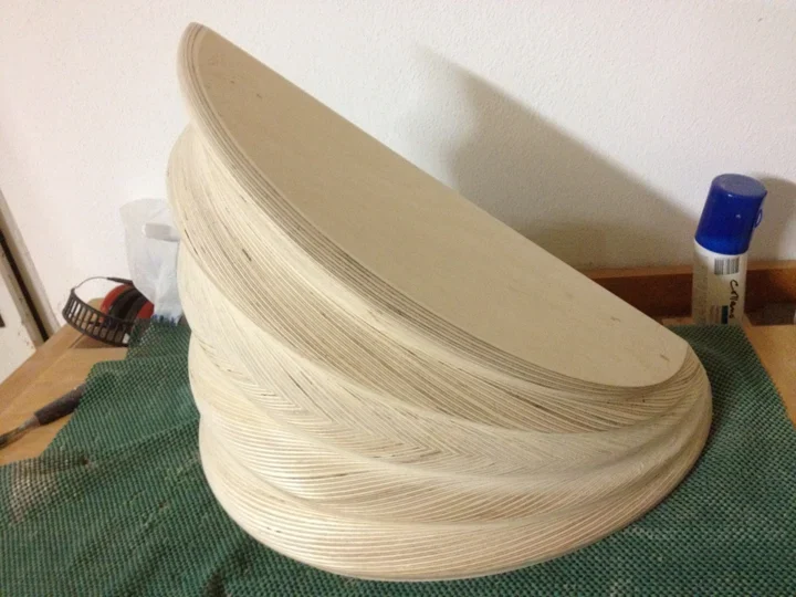 Shaped plywood pressing form with visible laminated layers